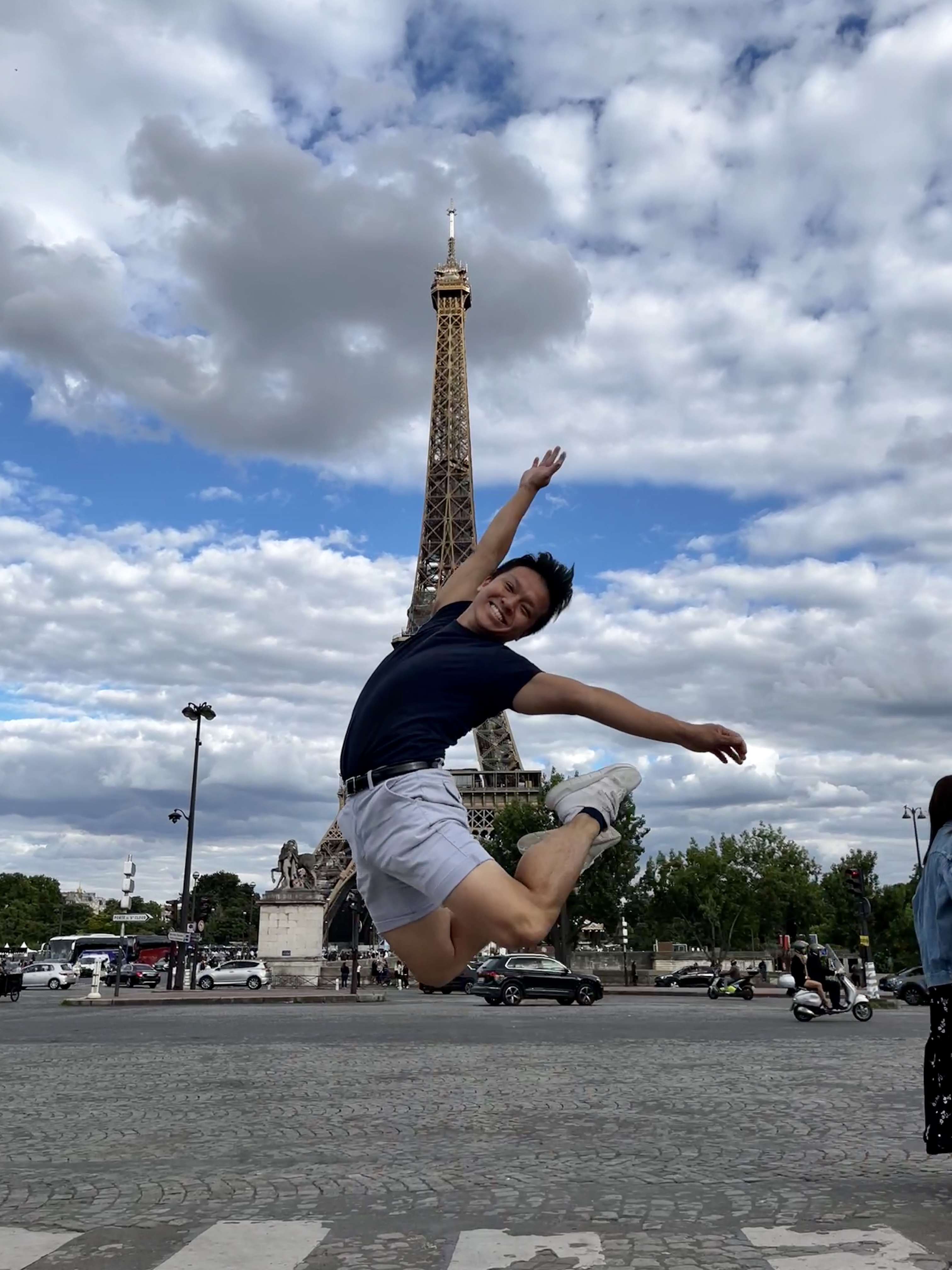 Johnny Dinh-Phan leaps into the air in front of the Eiffle Tower
